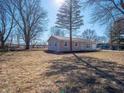 Well-kept home featuring a manicured lawn, established trees, and an attached one-car garage at 5197 Oakridge Dr, Mooresville, IN 46158