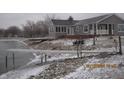Scenic view of the backyard with a deck, a pier, and lake access at 5820 N Nebo Rd, Muncie, IN 47304
