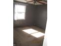 Simple bedroom featuring carpeted floors, a window, and neutral wall paint at 5820 N Nebo Rd, Muncie, IN 47304