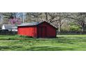 Bright red outbuilding with a dark trim under a grey shingle roof at 6954 E County Road 100 S, Avon, IN 46123