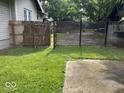 Backyard featuring well-maintained grass, a concrete slab, and wooden fences at 744 Wallace Ave, Indianapolis, IN 46201