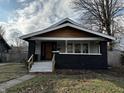 Charming home with a cozy front porch and black and white exterior at 744 Wallace Ave, Indianapolis, IN 46201