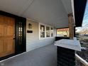 The house has a cozy front porch with gray floors, black trim, and a wooden front door at 744 Wallace Ave, Indianapolis, IN 46201