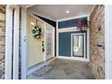 Charming front porch with a pop of color from the yellow door and hanging flower basket at 8061 Lower Bay Ln # 1, Indianapolis, IN 46236