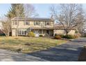 Two-story house with stone accents, solar panels, covered front porch, and driveway at 9080 Dewberry Ct, Indianapolis, IN 46260