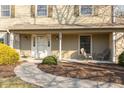 Inviting covered front porch with stone accents, seating, and well-maintained landscaping at 9080 Dewberry Ct, Indianapolis, IN 46260