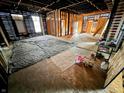 Wide interior view of home with exposed studs, framing, and floors at 120 Wisconsin St, Indianapolis, IN 46225
