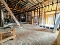 Interior view of a home with exposed framing and unfinished floors at 120 Wisconsin St, Indianapolis, IN 46225