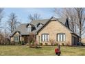 Attractive single-Gathering house with brick exterior, trimmed bushes, and a green lawn on a sunny day at 13852 Silver Stream Dr, Carmel, IN 46032