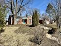 Charming single-story home with brick facade and blue front door on a well-maintained lawn at 1410 E 8Th St, Anderson, IN 46012