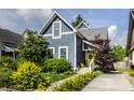 Charming blue home featuring manicured landscaping and a welcoming yellow front door with a decorative wreath at 1424 S New Jersey St, Indianapolis, IN 46225