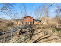 Backyard view of the house showing the chicken coop area and grassy yard at 1431 W Edgewood Ave, Indianapolis, IN 46217
