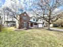 Two-story brick and vinyl home with attached two-car garage sits on well-maintained lawn at 1470 Northern Valley Trl, Avon, IN 46123