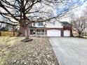 Two-story home with brick and vinyl siding, attached garages, and a well-manicured front yard at 1470 Northern Valley Trl, Avon, IN 46123