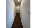 Clean hallway with smooth walls, wood-look floors, and doors leading to various rooms at 1509 S Hawthorne Ln, Indianapolis, IN 46203