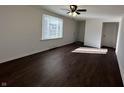Inviting living room with a ceiling fan, a bright window, and rich wood-look flooring at 1509 S Hawthorne Ln, Indianapolis, IN 46203