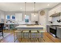 Spacious kitchen boasting a large center island, white cabinetry, stainless steel appliances, and designer lighting at 15297 Fairlands Dr, Westfield, IN 46074
