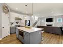 Open kitchen features a large center island with built-in microwave, stainless appliances, and seamless flow to the living room at 15297 Fairlands Dr, Westfield, IN 46074