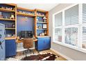 Cozy home office with custom built-in shelving, a large window, and a comfortable workspace at 16808 Audley Ave, Westfield, IN 46074
