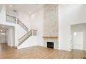 Spacious living room with a stone fireplace and elegant staircase at 19854 Chatham Shore Ln, Westfield, IN 46074