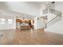 Bright, open-concept living space featuring a modern kitchen, staircase, and wood floors at 19854 Chatham Shore Ln, Westfield, IN 46074