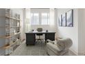 Bright home office with stylish desk, shelving, and comfortable seating area at 19854 Chatham Shore Ln, Westfield, IN 46074