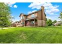 A nicely manicured front lawn leads to a brown two-story home, with a covered porch, American flag, and attached two-car garage at 211 Deborah Ln, Whiteland, IN 46184