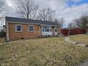 Traditional brick ranch home offering a cozy front porch and manageable front yard at 2113 Silver St, Anderson, IN 46012