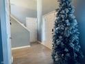 Bright foyer with a high ceiling, wood-look floors, and a decorative Christmas tree at 254 Halldale Dr, Whiteland, IN 46184