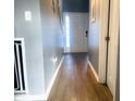 Inviting hallway featuring wood-look tile floors and neutral wall paint at 254 Halldale Dr, Whiteland, IN 46184