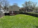 Spacious backyard with lush green grass, enclosed by a wooden fence, offering plenty of room for outdoor activities at 3060 S Lyons Ave, Indianapolis, IN 46241