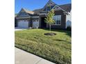 Attractive brick home with a well-kept lawn and a young shade tree in the front yard at 3613 Chalmers Dr, Bargersville, IN 46106