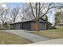 View of single-story home with a attached garage and long driveway at 3707 Chadwick Dr, Carmel, IN 46033
