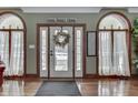 Inviting foyer with hardwood floors, arched doorways, and a decorative wreath on the front door at 3762 N Foxcliff E Dr, Martinsville, IN 46151