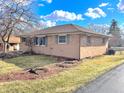A single-story brick home with a manicured lawn is located on a tree-lined street at 505 Birch St, Beech Grove, IN 46107