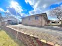 This single-story brick home features a detached garage and a long driveway at 505 Birch St, Beech Grove, IN 46107