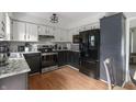 Well-lit kitchen featuring stainless steel appliances and a two-tone cabinet design at 520 N Pine St, Morgantown, IN 46160