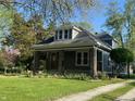 Quaint home with a well manicured front yard, gravel driveway and lush mature trees at 5533 Wilson Way, Jamestown, IN 46147