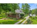 Charming single-Gathering home with landscaped front yard, inviting porch, and gravel driveway at 5533 Wilson Way, Jamestown, IN 46147