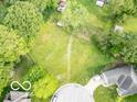 Expansive lot with lush greenery, mature trees, and a partial view of neighboring houses at 651 Rylan Cir, Greenwood, IN 46142