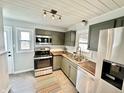 Updated kitchen featuring stainless steel appliances, modern cabinets and a butcher block countertop at 7047 Evanston Ave, Indianapolis, IN 46220