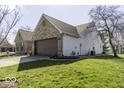 A great look at the side exterior, 2-car garage, landscaping and well maintained yard at 7425 Monterey Cir, Avon, IN 46123
