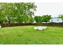 Spacious, fenced backyard featuring a garden bed, providing plenty of room for outdoor activities at 812 Madison St, Frankton, IN 46044