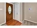 Welcoming entryway featuring hardwood floors, a decorative front door, and neutral wall paint at 812 Madison St, Frankton, IN 46044