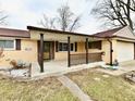 Inviting front porch with decorative railing, covered entry, and manicured landscaping at 812 Madison St, Frankton, IN 46044