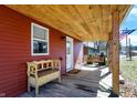 Covered porch featuring rustic wood and a decorative bench, creating a welcoming outdoor space at 8657 S Nash Dr, Nineveh, IN 46164