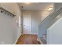 Entryway featuring a coat rack, wood laminate flooring, and staircase at 917 Claiborne Ln, Lebanon, IN 46052