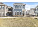 Beautiful two-story blue home with a well-maintained lawn and classic architecture in a residential neighborhood at 1004 Astor Ln, Carmel, IN 46032