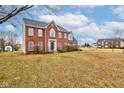 Beautiful two-story brick house with a manicured lawn and inviting curb appeal at 10046 Gate Dr, Indianapolis, IN 46239