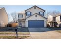 Charming two-story home with a driveway, blue shutters, and a well-maintained lawn at 10725 Chenille Ct, Indianapolis, IN 46235
